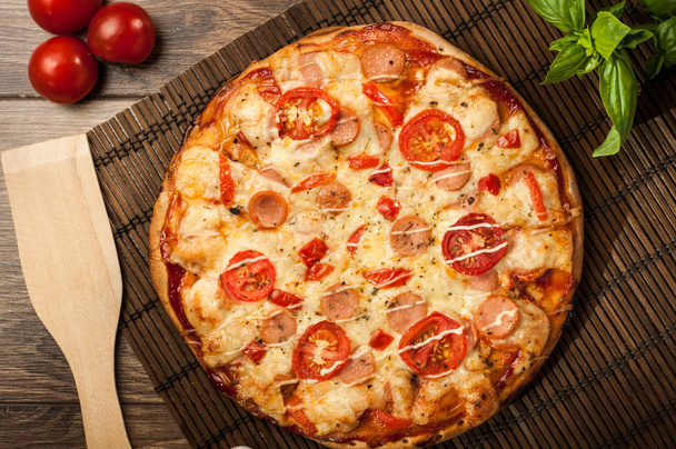 Delicious fresh pizza served on wooden table - Φωτογραφία, εικόνα