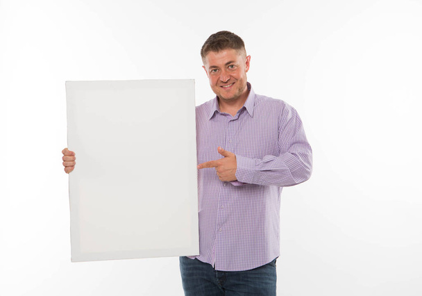 Young happy man showing presentation, pointing on placard. - Photo, image