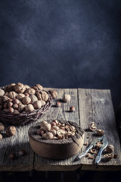 Delicious walnuts and hazelnuts with on rustic wooden table - Valokuva, kuva