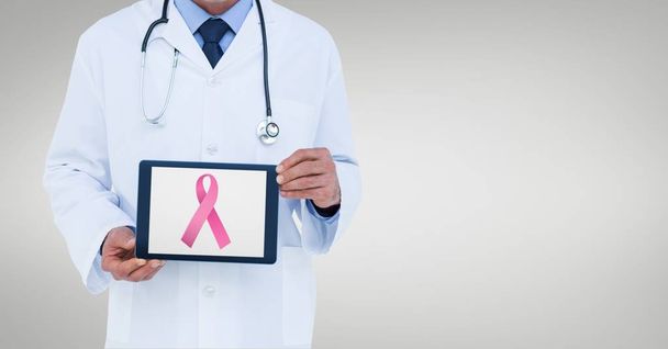 Doctor holding a tablet with a breast cancer  - Φωτογραφία, εικόνα