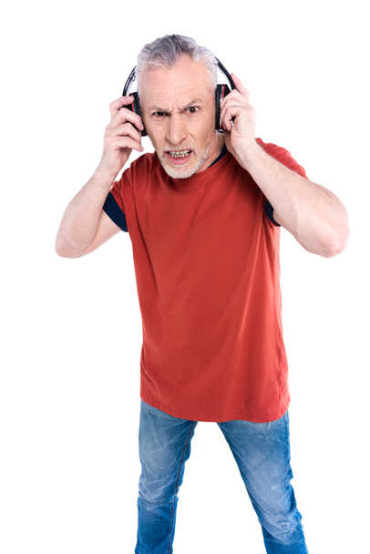 Angry senior man in big headphones - Foto, Bild