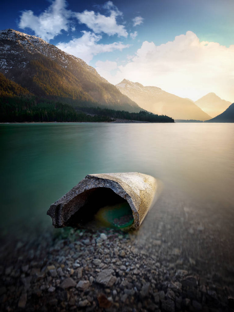 Landscape of Plansee and Alps mountains. Concrete block lying in lake, Tyrol, Austria - Photo, Image