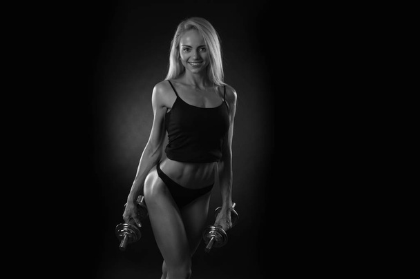 sporty muscular woman working out with dumbbells - Zdjęcie, obraz