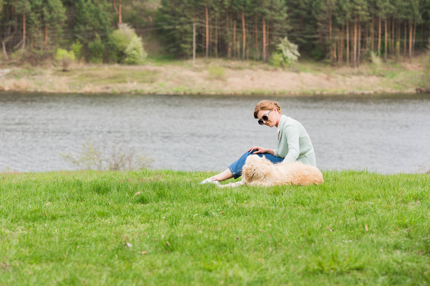 woman with dog on grass - Photo, Image