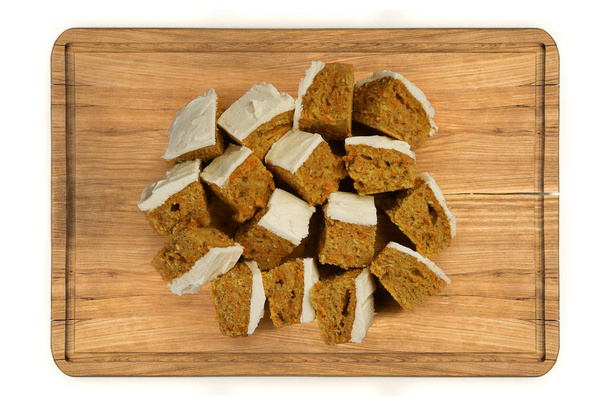 Mini pieces of carrot cake on wooden plate - Photo, Image