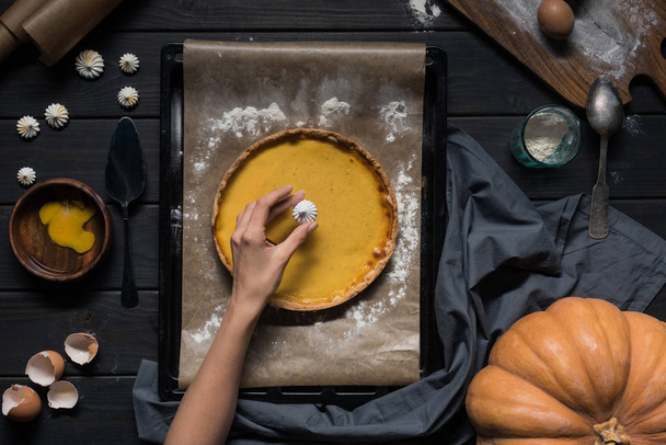 female hand placing meringue onto pie - Photo, Image