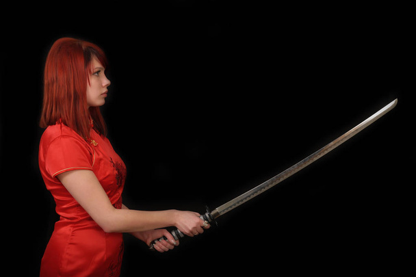 Young redhead girl with katana - Photo, Image