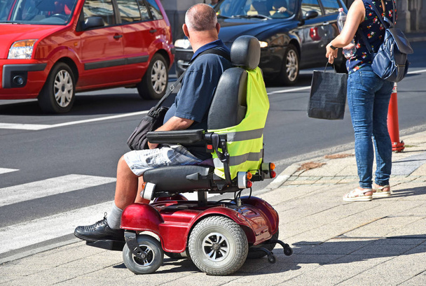 Άνθρωπος με ηλεκτρικό αναπηρικό αμαξίδιο - Φωτογραφία, εικόνα