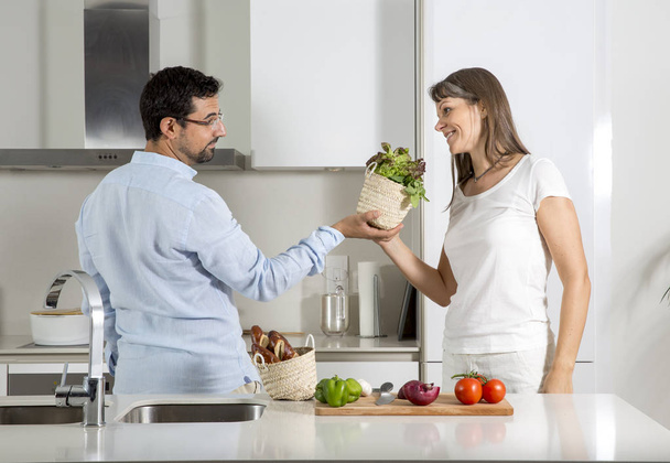 couple preparing food in kitchen  - Фото, зображення