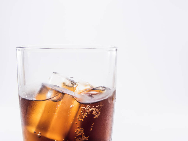 close up two of thirds soft drink is cool and ice cubes  in glass on white background - Photo, image