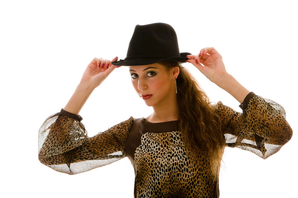Posing model in a sexual dress and in a hat - Foto, Imagen