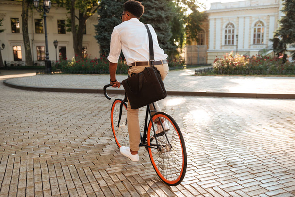 African man early morning with bicycle walking outdoors - Foto, Imagen
