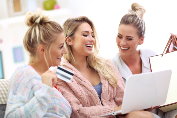 Three beautiful young women shopping online - Photo, Image