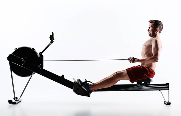 Man Using A Press Machine In A Fitness Club. - Foto, Bild