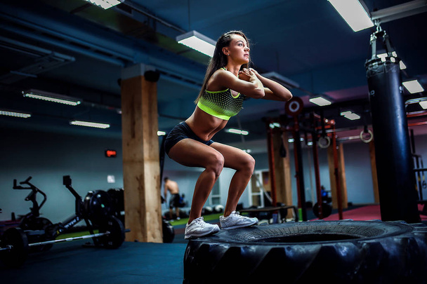 Fit young woman box jumping at a crossfit style. - 写真・画像