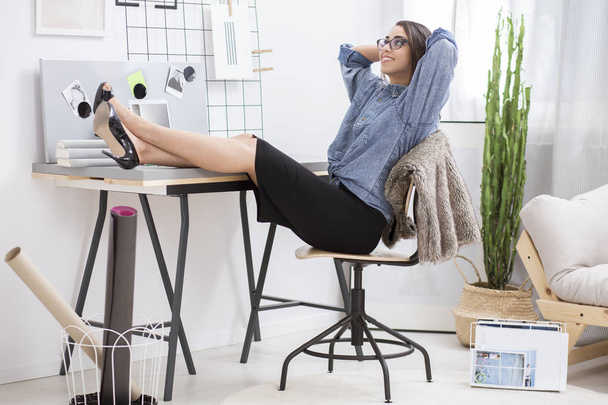 Female entrepreneur resting in office - Photo, Image