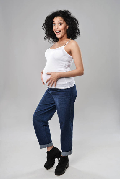 Pregnant woman standing in full length - 写真・画像