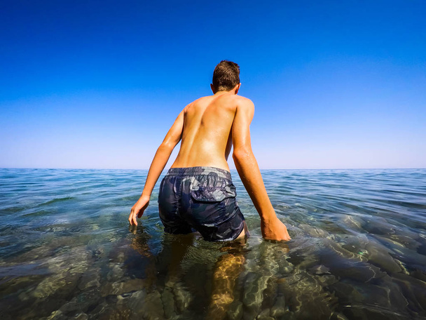 teenager ready to swim in the sea - summertime - Photo, Image