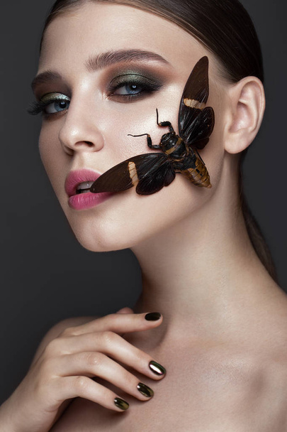 Portrait of beautiful girl with colorful make-up and cicada. Beauty face. - Photo, Image