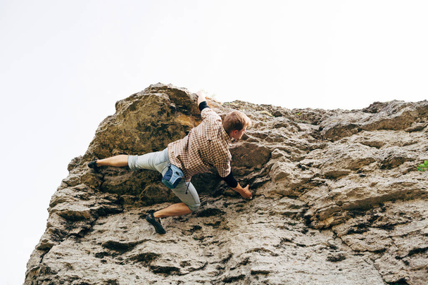 Man climbing up rock - Photo, Image