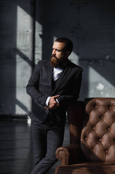 Bearded young businessman standing on modern loft office - Photo, Image