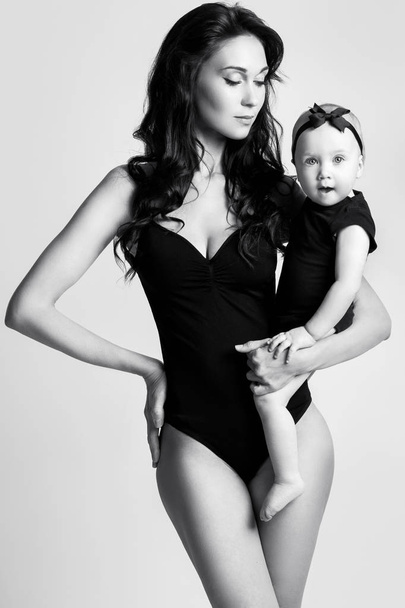 Young mother and her beautiful daughter - 写真・画像
