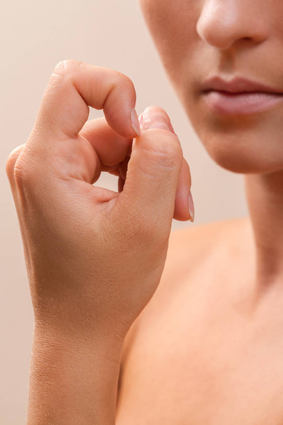 Woman bitting her fingers - Zdjęcie, obraz