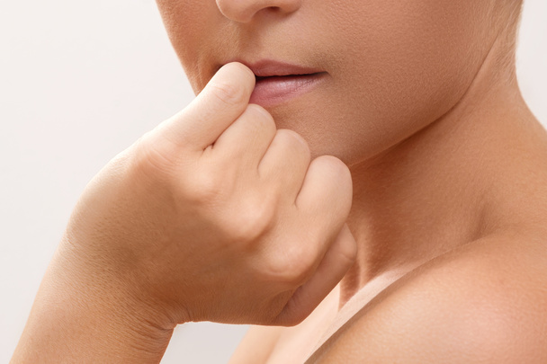 Woman bitting her finger - Photo, image