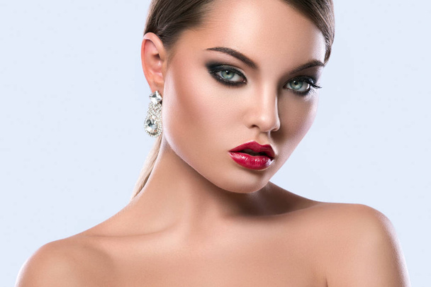 Portrait of young woman with beautiful earrings - Foto, imagen