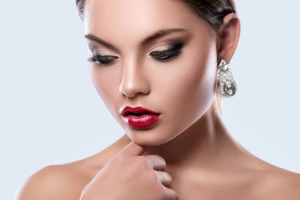 Portrait of young woman with beautiful earrings - Φωτογραφία, εικόνα