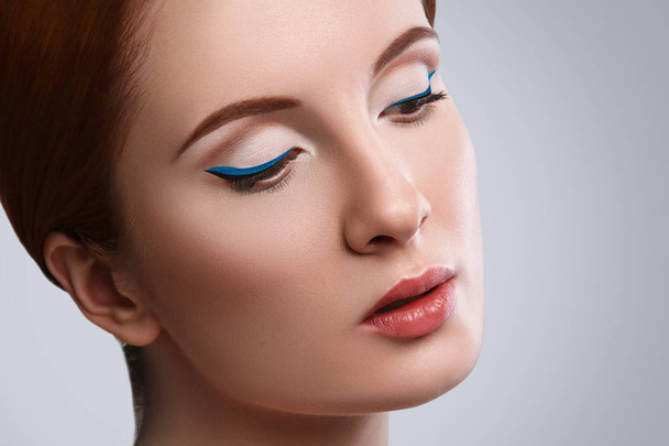 Woman with blue eyeliner - Фото, изображение