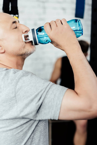 senior sportsman drinking water  - Photo, Image