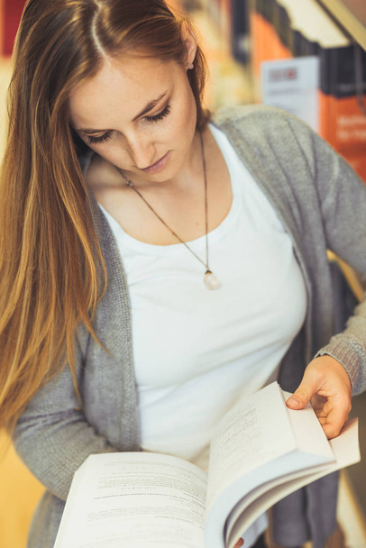 pretty female student learning in a high school library  - Fotó, kép