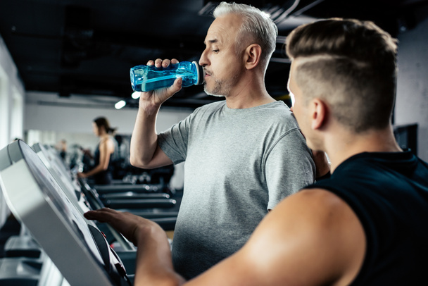 senior sportsman training on treadmill - Fotó, kép