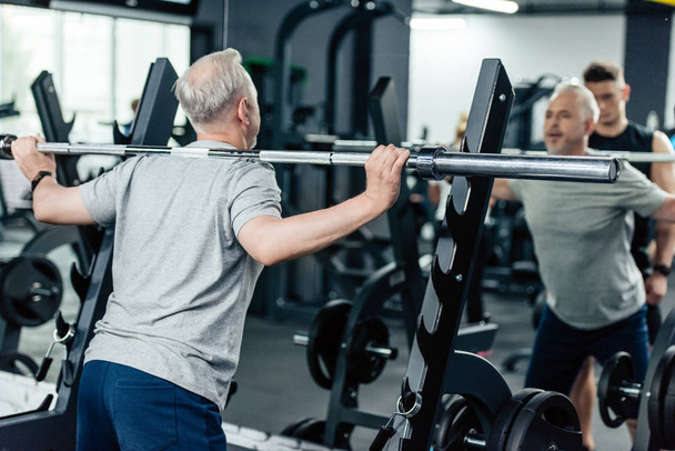 senior sportsman lifting barbell  - Foto, imagen