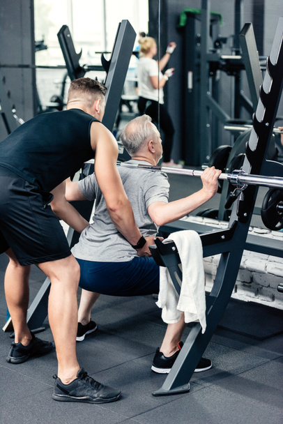 senior sportsman lifting barbell  - Fotografie, Obrázek
