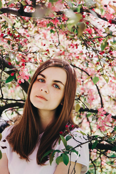 Girl near blossoming tree. - Valokuva, kuva