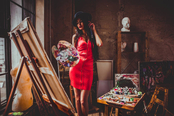 Young woman painter in her studio make some art - Fotó, kép