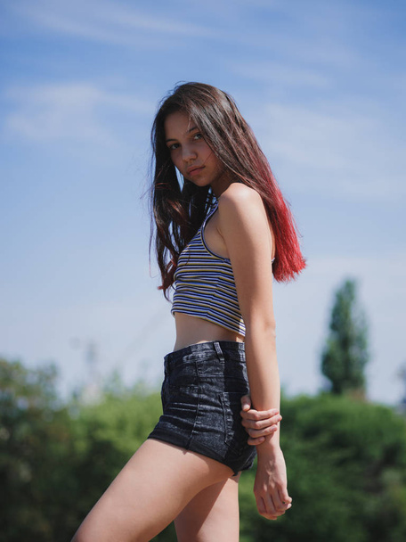 A portrait of a charming teenage girl in summer clothes posing on a natural background. Fashion, youth concept. Copy space. - Fotografie, Obrázek