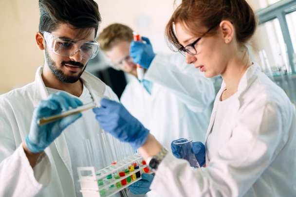 Young students of chemistry working in laboratory - Zdjęcie, obraz