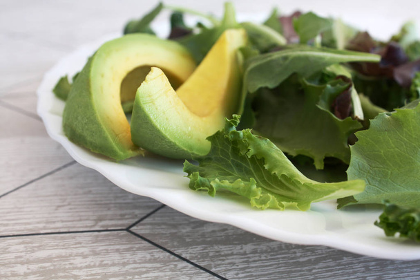 salad avoado on the white plate - Foto, Imagem