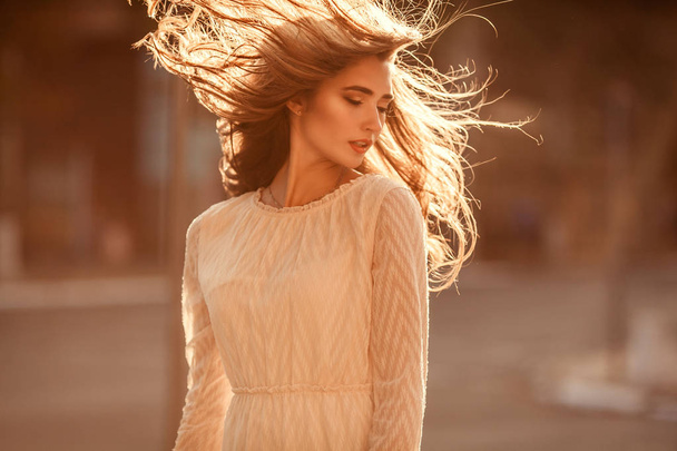 Beautiful young lady with long healthy hair and cute dress i - Foto, imagen