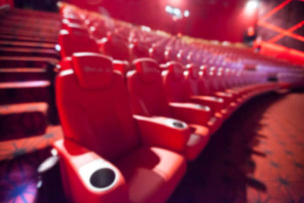 Blurry background of red seat in the movie theater. - Фото, изображение