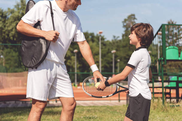 Interested boy going to play though racket - Foto, Imagem