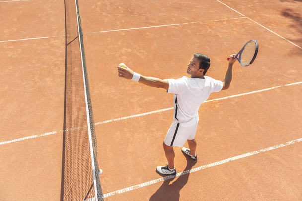 Serious male person playing tennis - Photo, Image