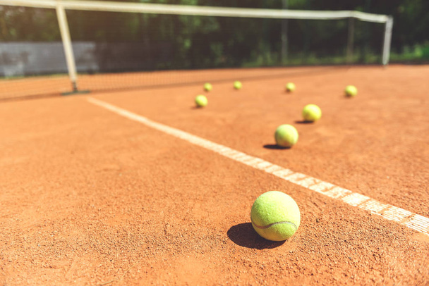 Various yellow small round balls on court - Foto, immagini