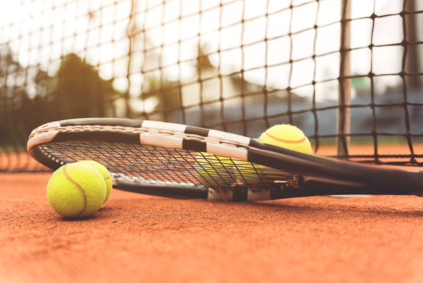 Necessary tennis equipment near net - Photo, image