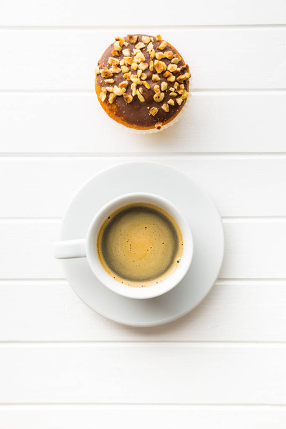 Coffee cup and hazelnut muffin. - Фото, зображення