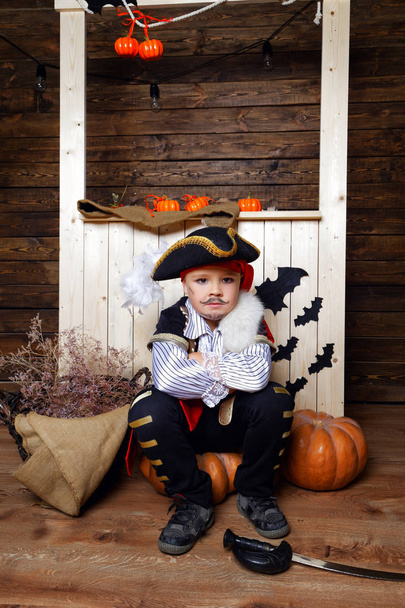 Funny boy in pirate costume in the studio with scenery for Halloween - Zdjęcie, obraz