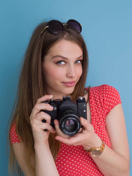 beautiful girl taking photo on a retro camera - Fotó, kép